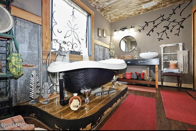 interior space featuring wood-type flooring, wooden ceiling, and vanity