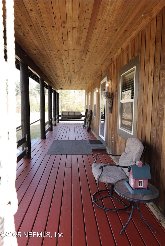 wooden terrace featuring covered porch