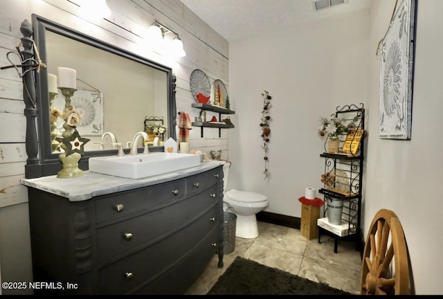 bathroom featuring vanity, toilet, and tile patterned flooring