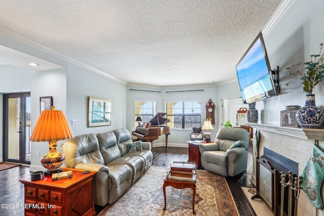 living room with crown molding, wood-type flooring, and a textured ceiling