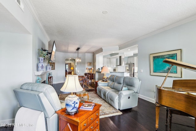 living room featuring ornamental molding, dark hardwood / wood-style floors, and a textured ceiling