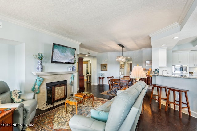 living room featuring crown molding, dark hardwood / wood-style floors, and a textured ceiling