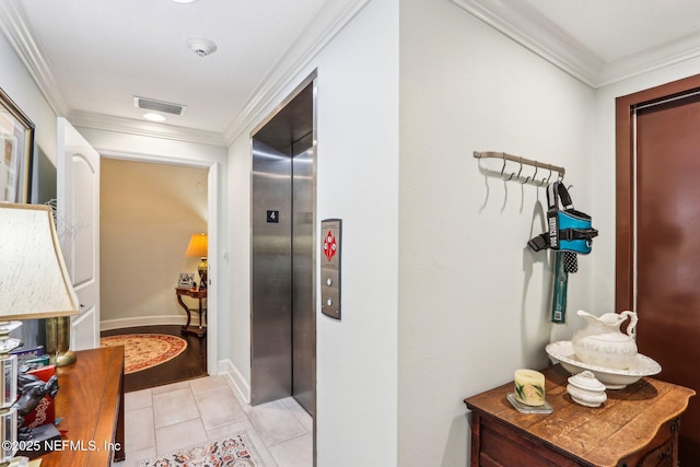 hallway with ornamental molding, elevator, and light tile patterned floors