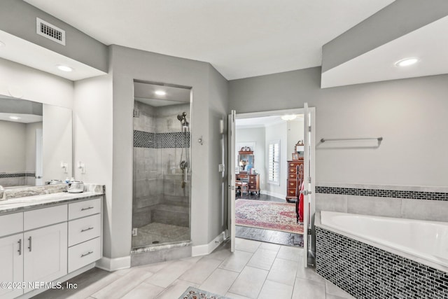 bathroom featuring vanity and separate shower and tub