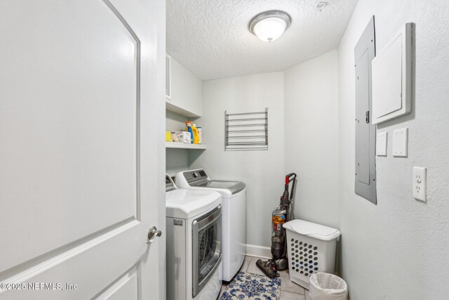 clothes washing area featuring light tile patterned floors, independent washer and dryer, and a textured ceiling