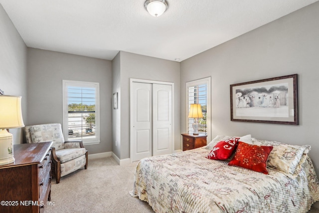 bedroom with light carpet and a closet