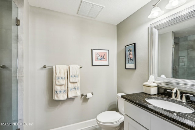 bathroom featuring vanity, toilet, and an enclosed shower