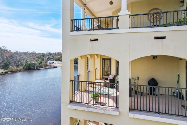 exterior space featuring a balcony and a water view