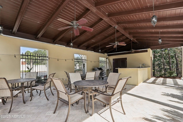 view of patio with a bar and ceiling fan