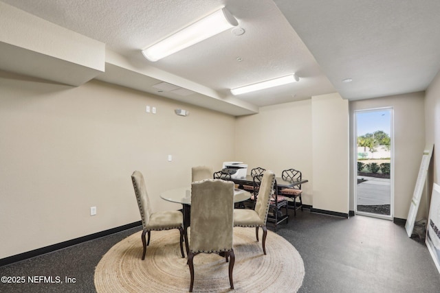 dining space featuring a textured ceiling