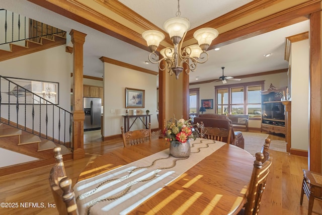 dining space featuring ceiling fan with notable chandelier, ornamental molding, light hardwood / wood-style floors, and ornate columns