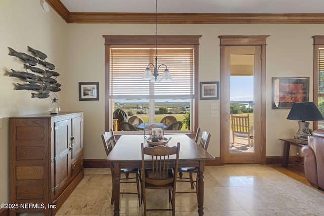 dining area featuring an inviting chandelier and ornamental molding