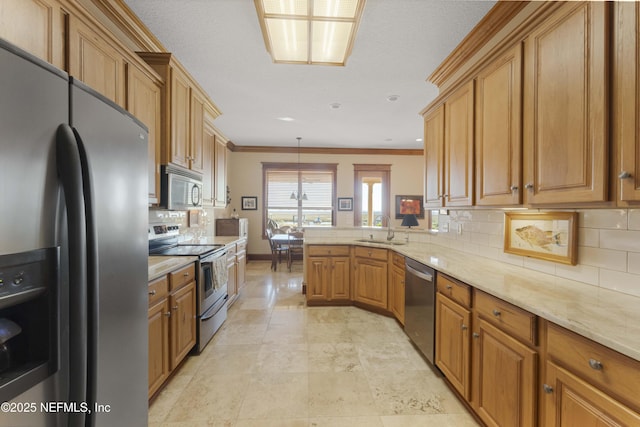 kitchen featuring stainless steel appliances, kitchen peninsula, sink, and backsplash