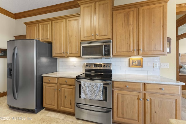 kitchen with crown molding, light tile patterned floors, stainless steel appliances, light stone countertops, and backsplash