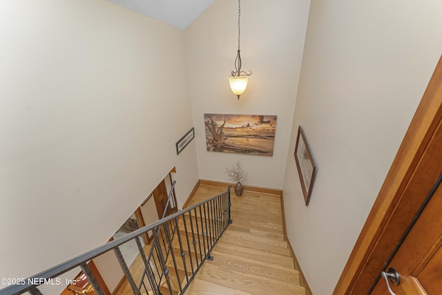 stairs featuring hardwood / wood-style floors