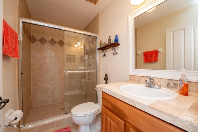 bathroom featuring walk in shower, vanity, a textured ceiling, and toilet