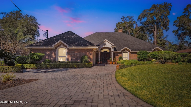 ranch-style home with a yard