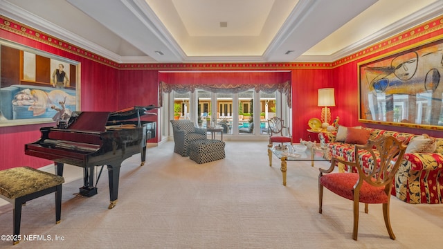 living area with carpet flooring and a tray ceiling