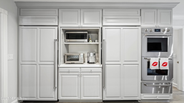 kitchen featuring light wood-type flooring and appliances with stainless steel finishes