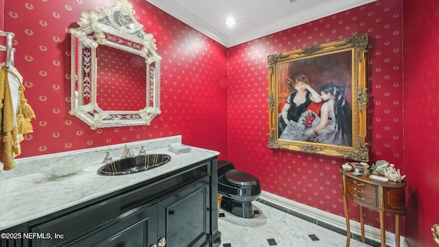 bathroom with ornamental molding, vanity, and toilet