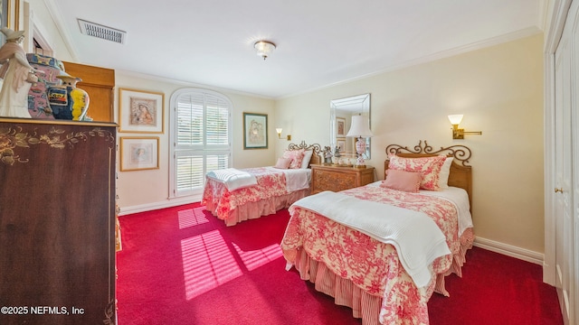 carpeted bedroom with ornamental molding