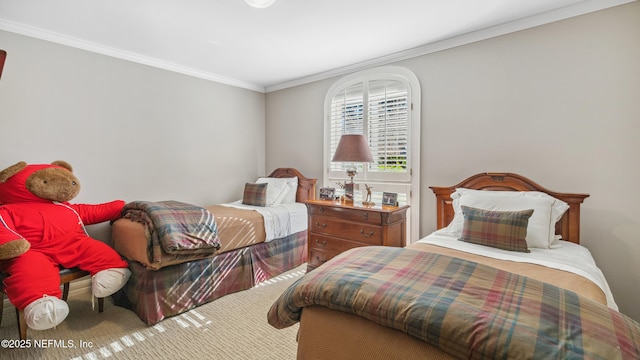 bedroom featuring ornamental molding and carpet flooring