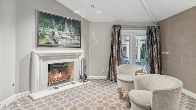 sitting room featuring french doors and lofted ceiling