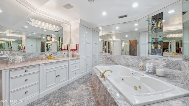 bathroom featuring vanity and tiled bath