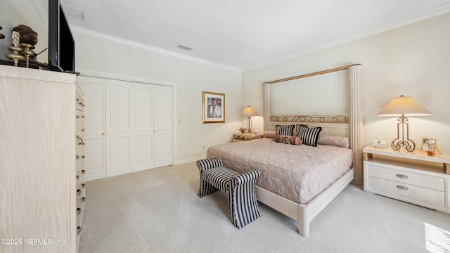 bedroom featuring a closet, ornamental molding, and light carpet