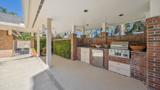 view of patio / terrace with area for grilling, sink, and an outdoor kitchen