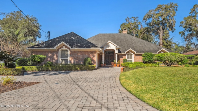 ranch-style home featuring a front yard