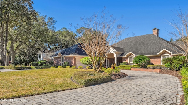 view of front of home with a garage and a front lawn