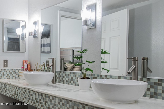 bathroom featuring vanity and decorative backsplash