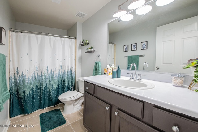 bathroom with tile patterned flooring, vanity, and toilet