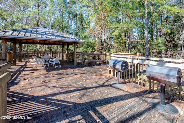 wooden terrace featuring a gazebo