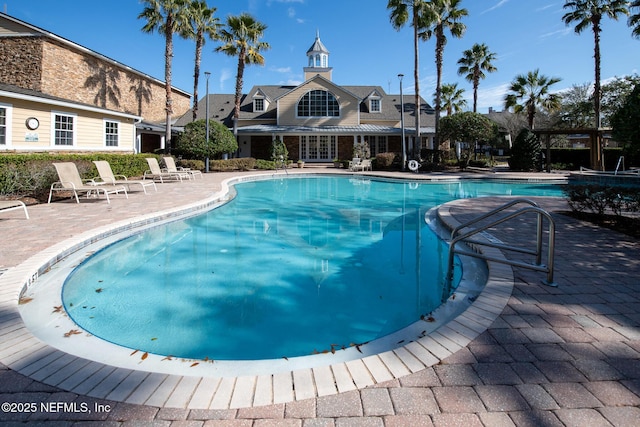 view of swimming pool featuring a patio area