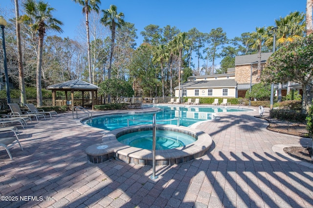 view of swimming pool featuring a gazebo, a patio area, and a hot tub