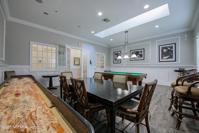 dining space with ornamental molding, dark hardwood / wood-style floors, billiards, and a skylight