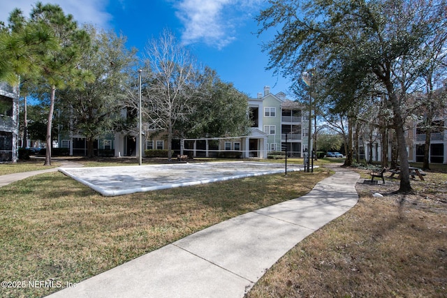 view of home's community featuring a yard and volleyball court