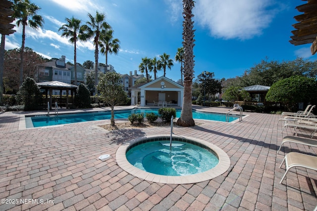 view of swimming pool with a community hot tub, a patio area, and a gazebo