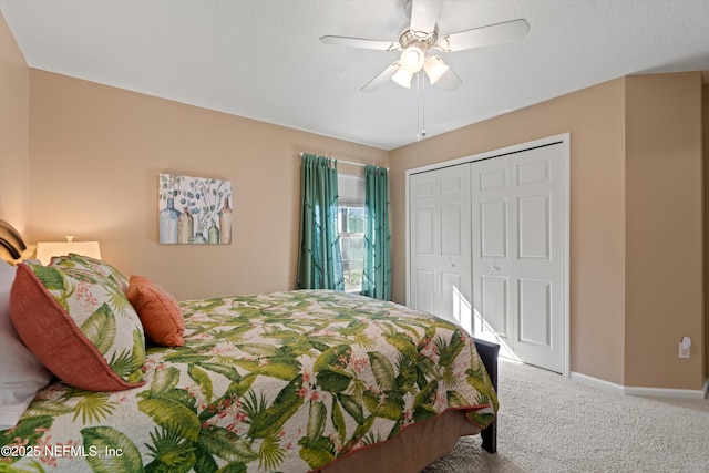 bedroom with ceiling fan, a closet, carpet, and a textured ceiling