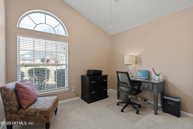 home office featuring light carpet and vaulted ceiling