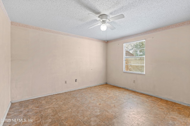 unfurnished room with ceiling fan and a textured ceiling