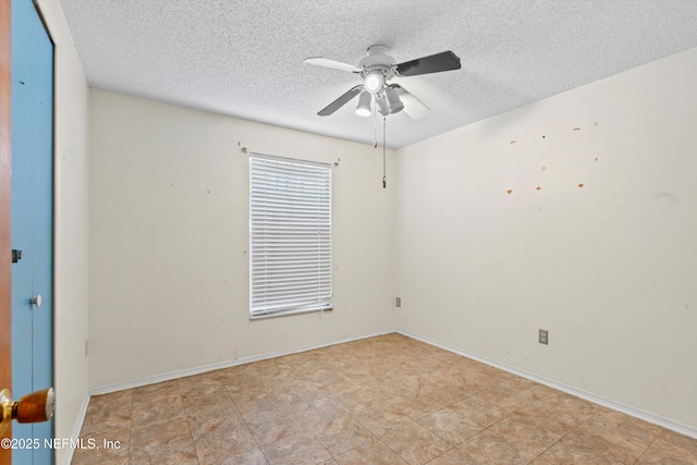 empty room with a textured ceiling and ceiling fan