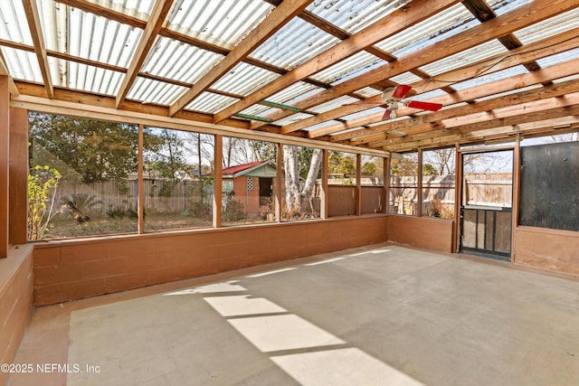 unfurnished sunroom featuring ceiling fan