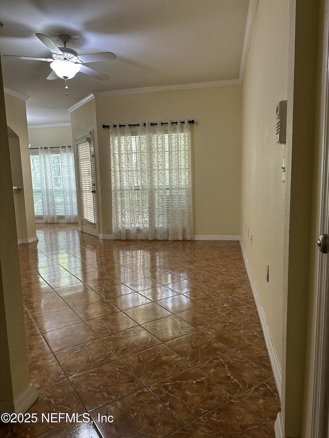 empty room with crown molding, ceiling fan, and a wealth of natural light