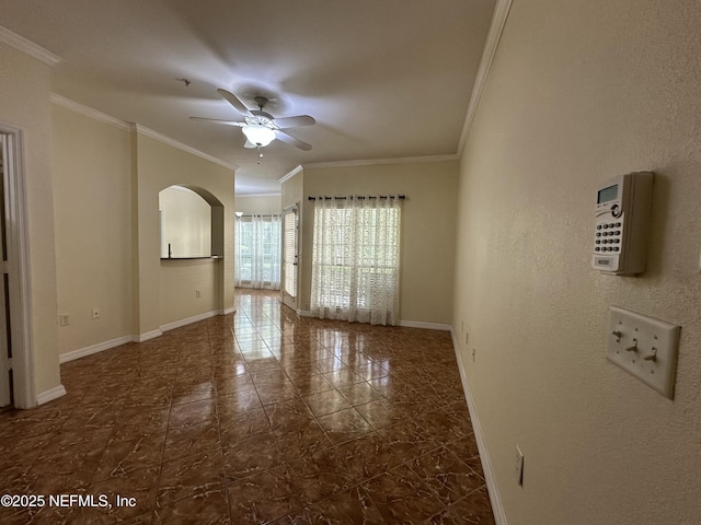 spare room with ornamental molding and ceiling fan