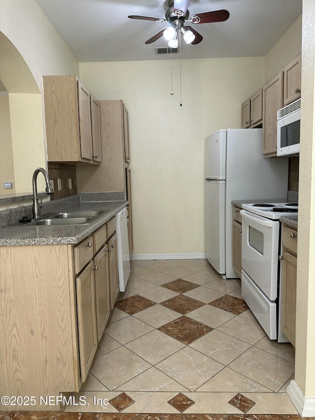 kitchen with sink, white appliances, light tile patterned floors, ceiling fan, and light brown cabinets