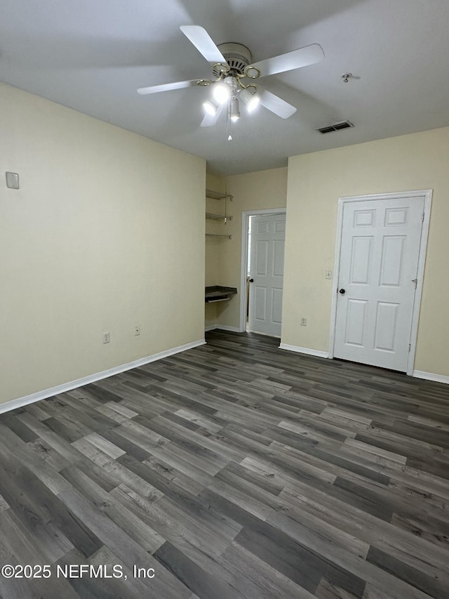 unfurnished bedroom with ceiling fan, dark hardwood / wood-style floors, and a closet