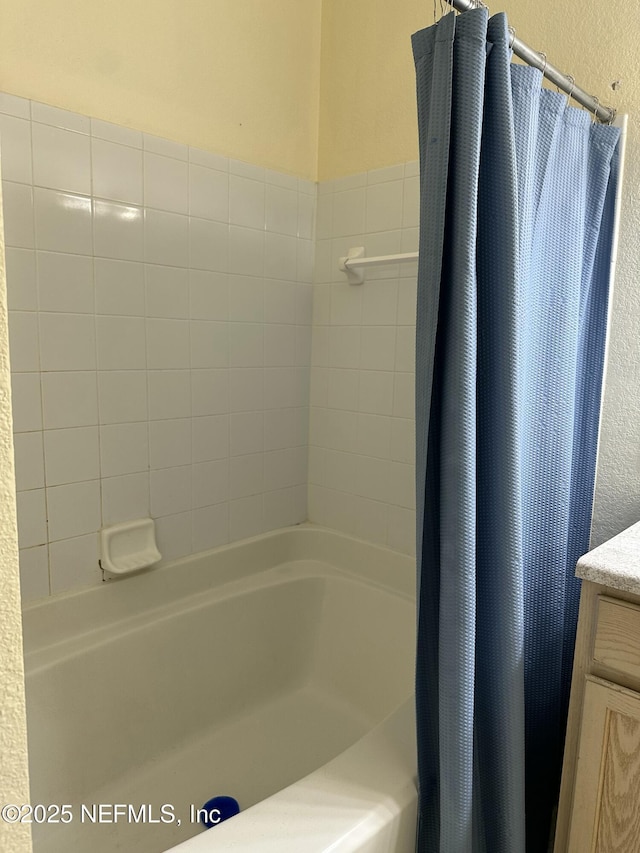 bathroom with vanity and shower / bath combination with curtain